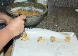 Drop cookies onto parchment lined cookie sheets by Randy Cockrell